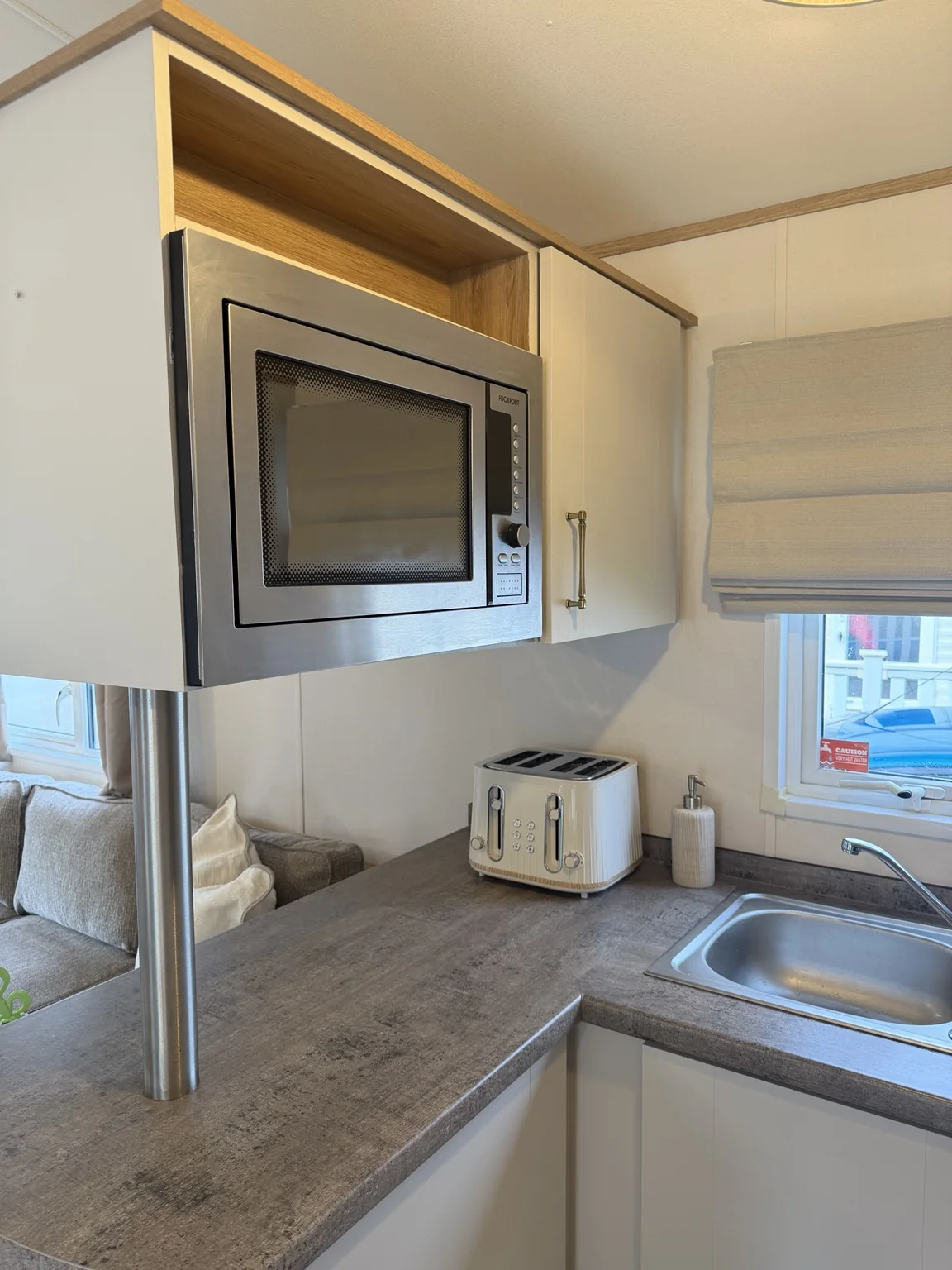 Kitchen worktop with microwave, toaster and sink